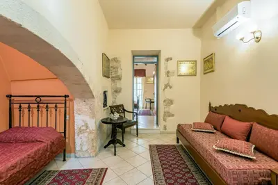 a living room with a couch and a table at Belmondo Hotel in Chania Town