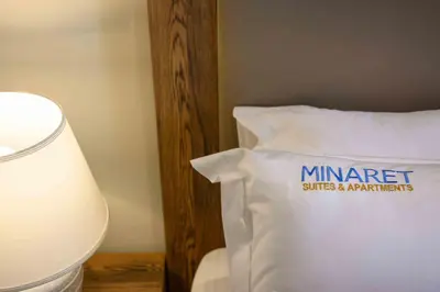 a bed with a pillow with a sign on it at Minaret Suites and Apartments in Chania Town