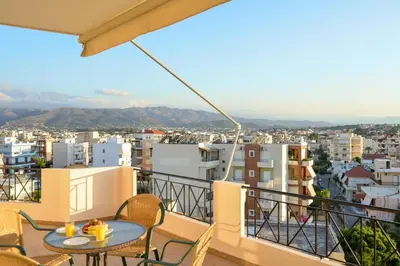 a balcony with a table and chairs and a city at Elia Selinou in Chania Town