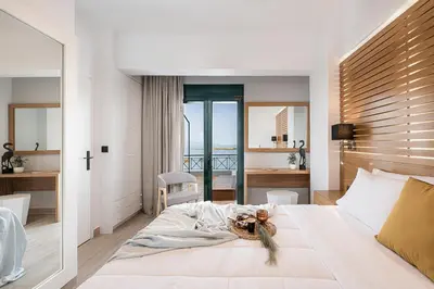 a bedroom with a large bed with a view of the ocean at Elia Penthouse in Chania Town
