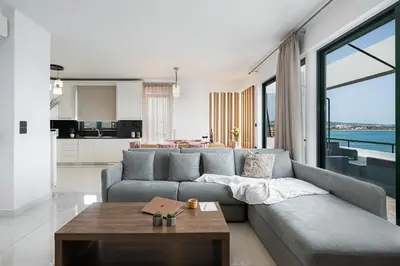 a living room with a couch and a table at Elia Penthouse in Chania Town