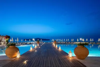 a row of vases on a wooden walkway with lights at Leptos Panorama Hotel in Kalamaki Chanion