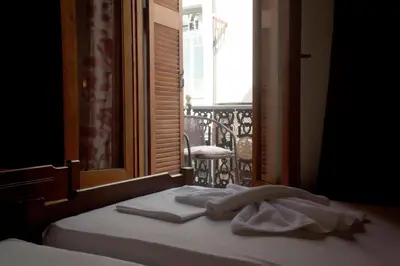 a bed with towels on it in front of a window at Diporto in Chania Town