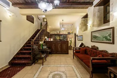 a living room with a staircase and a couch at Porto Del Colombo Traditional Boutique Hotel in Chania Town