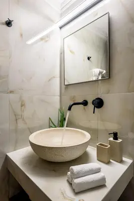 a bathroom with a bowl sink on a counter at Porto Del Colombo Traditional Boutique Hotel in Chania Town