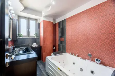a bathroom with a bath tub and a sink at Evgenias Luxury Apartment with Rooftop Pool in Chania Town