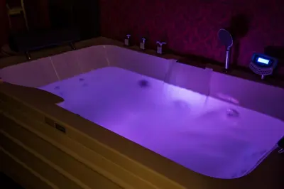 a bath tub with purple lighting in a bathroom at Evgenias Luxury Apartment with Rooftop Pool in Chania Town