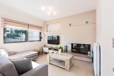 a living room with a couch and a table at Peris Villa in Kato Daratso
