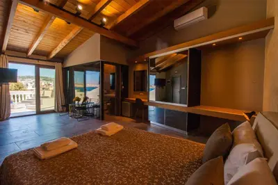 a large room with a bed and a living room at Minoos Hotel in Chania Town