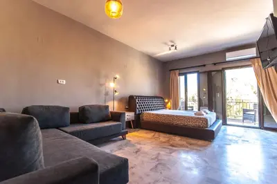 a living room with a couch and a bed at Minoos Hotel in Chania Town
