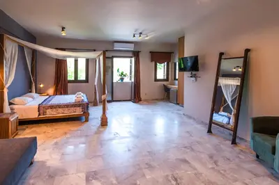 a bedroom with a bed and a television in it at Minoos Hotel in Chania Town