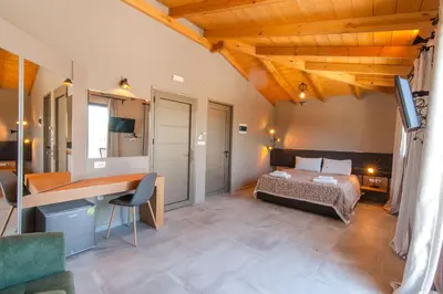 a bedroom with a bed and a desk in a room at Minoos Hotel in Chania Town