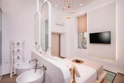 a white bathroom with two sinks and a mirror at Madonna del Mare in Chania Town