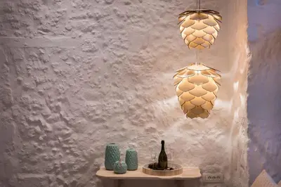 a table with a bottle of wine and two lights at Madonna del Mare in Chania Town