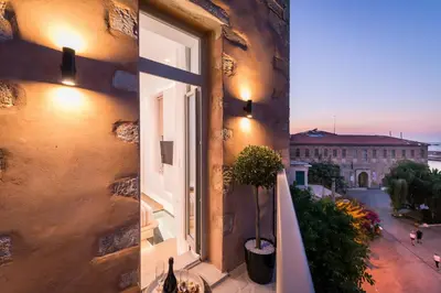 a window on a building with a view of a street at Madonna del Mare in Chania Town