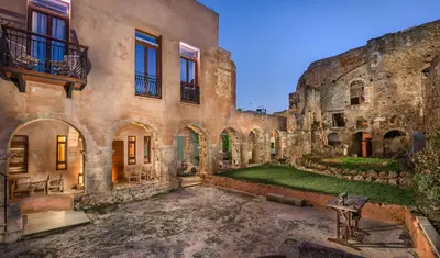 an old building with a yard in front of it at Madonna del Mare in Chania Town