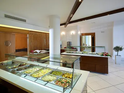 a bakery with many different types of pastries on display at Eleftheria Hotel in Agia Marina Nea Kydonias