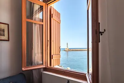 an open window with a view of the ocean at Villa Venezia in Chania Town