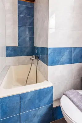 a bathroom with a blue and white tub and a toilet at Villa Venezia in Chania Town