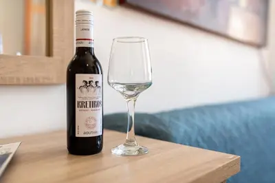 a bottle of wine sitting next to a wine glass at Villa Venezia in Chania Town