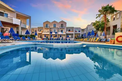 a swimming pool in a resort with chairs and condos at Bella Pais in Maleme