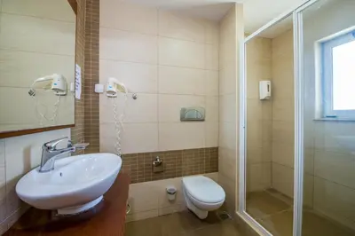 a bathroom with a sink and a shower and a toilet at Bella Pais in Maleme