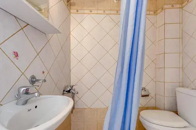 a bathroom with a sink and a toilet at Ifigenia Rooms in Chania Town