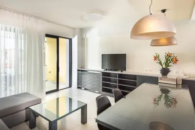a living room with a dining table and a television at Spring Apartments in Chania Town