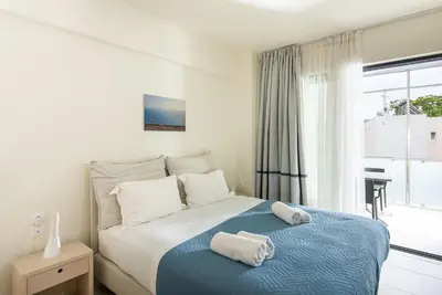 a bedroom with a bed with two towels on it at Spring Apartments in Chania Town