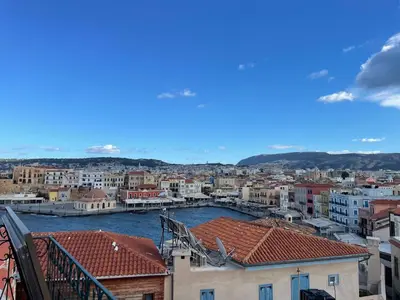 a view of a city with a river and buildings at Ifigenia Lux MAISONETTE in oldtown and Villas in theriso vilage 14 km outside of chania in Chania Town