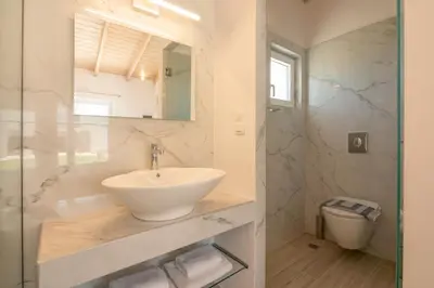 a bathroom with a sink and a toilet at GT Beach in Maleme