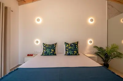 a bedroom with a large bed with two pillows at GT Beach in Maleme