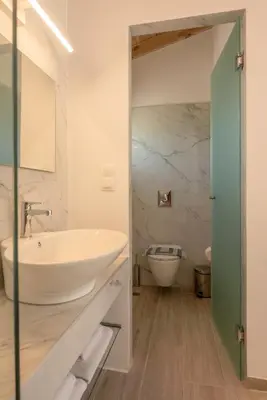 a bathroom with a white sink and a toilet at GT Beach in Maleme