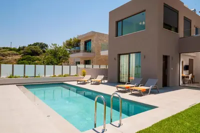 a house with a swimming pool next to a house at Eland Dream Villas in Kalamaki Chanion