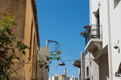 an alley with buildings and a blue sky at Casa Giulietta Modern Luxury Maisonette in Chania Town