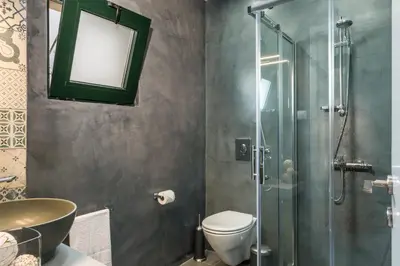 a bathroom with a shower and a toilet and a sink at Casa Giulietta Modern Luxury Maisonette in Chania Town