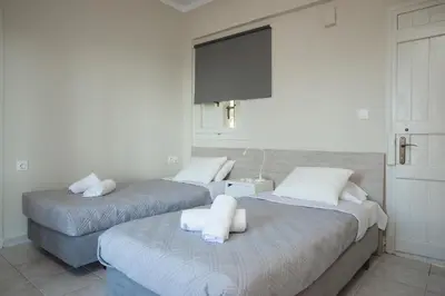 two beds with towels on them in a room at Popy's Place in Kato Daratso