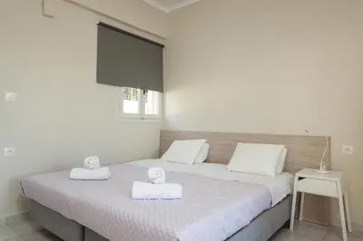 a bedroom with a bed with two towels on it at Popy's Place in Kato Daratso
