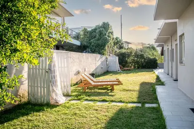 a bench sitting in a yard next to a fence at Popy's Place in Kato Daratso