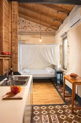 a kitchen with a sink and a bed in a room at Evans House in Chania Town