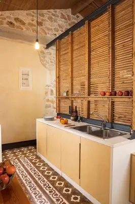 a kitchen with a sink and some wooden cabinets at Evans House in Chania Town
