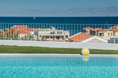 a yellow ball sitting on the edge of a swimming pool at Thea Thalassa in Kalamaki Chanion