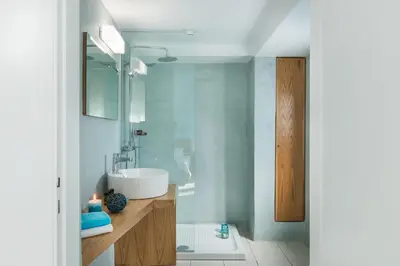 a bathroom with a white sink and a tub at Thea Thalassa in Kalamaki Chanion