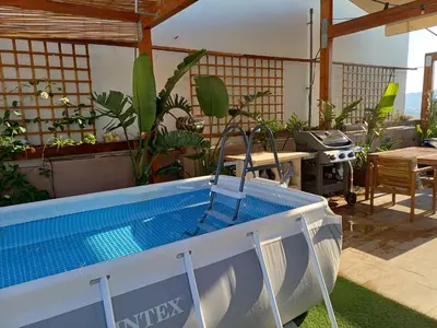 a hot tub in the middle of a patio with plants at ChaniaStay Central Apartments in Chania Town