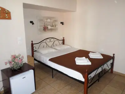 a bedroom with a bed and a table with towels on it at Tina Hotel in Chania Town