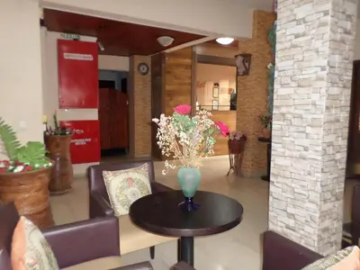 a table with a vase of flowers on top of it at Tina Hotel in Chania Town