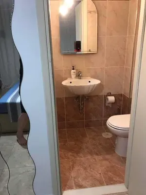 a bathroom with a sink and a toilet at The Endless Blue Maisonette in Palaiochóra