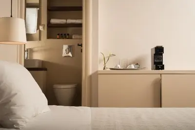 a bedroom with a white bed and a counter at Nonnalena Boutique Hotel in Chania Town