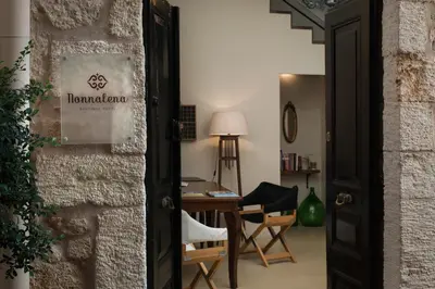 a door to a room with a table and chairs at Nonnalena Boutique Hotel in Chania Town