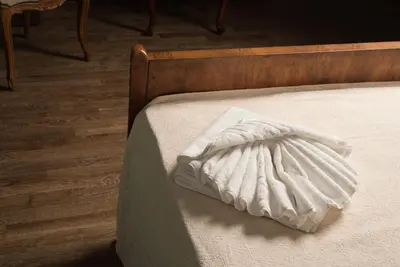 a white pillow sitting on top of a bed at Nonnalena Boutique Hotel in Chania Town